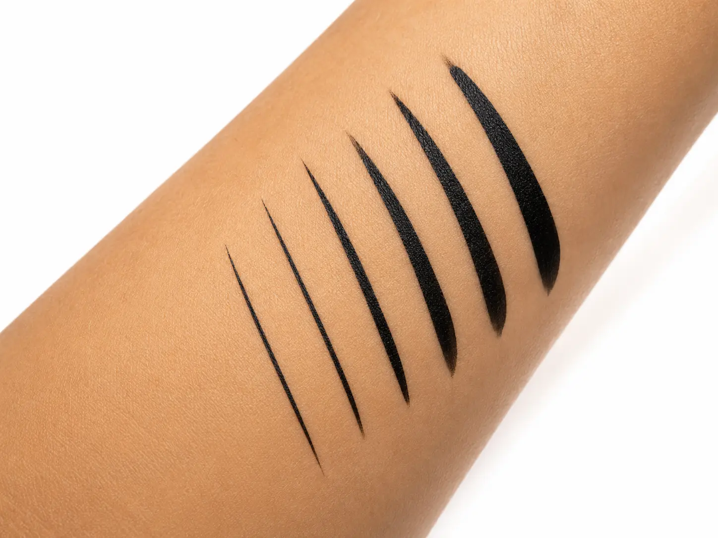 Waterproof eyeliner product on a clean vanity surface with water droplets